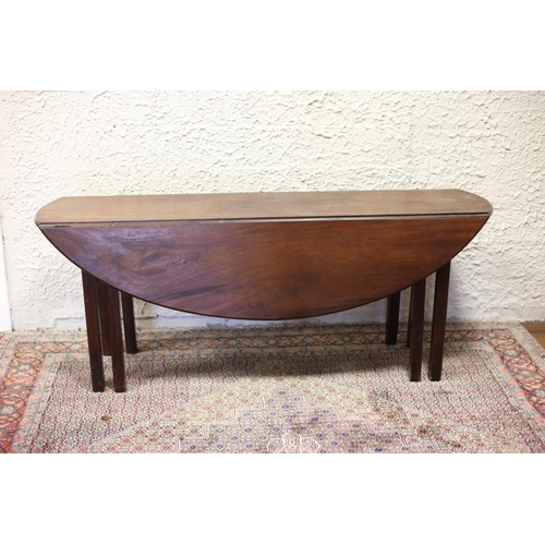 69 - A GEORGIAN MAHOGANY HUNT TABLE the oval hinged top raised on eight square moulded legs 72cm (h) x 18... 