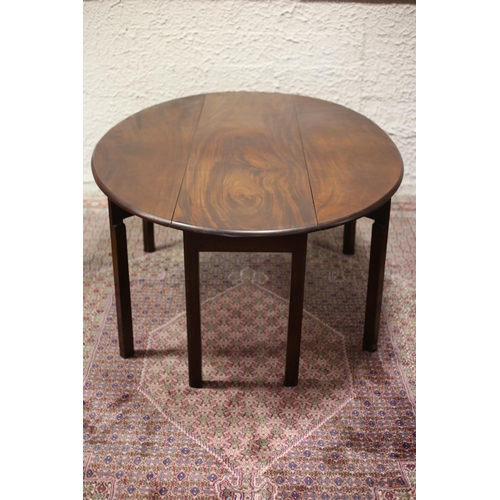 69 - A GEORGIAN MAHOGANY HUNT TABLE the oval hinged top raised on eight square moulded legs 72cm (h) x 18... 