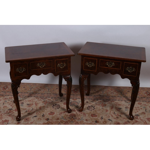 76 - A PAIR OF GEORGIAN DESIGN WALNUT CROSS BANDED SIDE TABLES each of rectangular outline with three fri... 