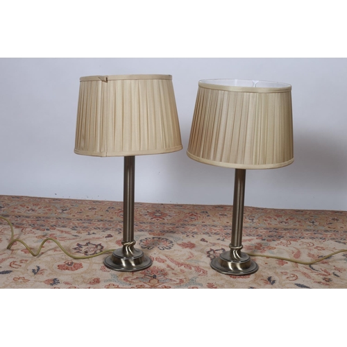 88 - A PAIR OF BRASS OXIDISED TABLE LAMPS each with reeded column above a circular stepped base with plea... 