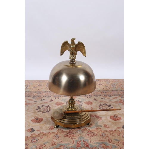 9 - A GOOD BRASS DINNER GONG surmounted by a winged eagle above a dome raised on a baluster column and s... 