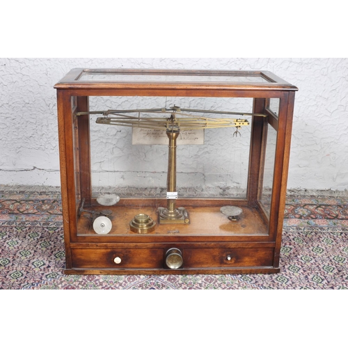 91 - A VINTAGE BRASS LABORATORY SCALES in mahogany and glazed case with two frieze drawers 50cm (h) x 57c... 