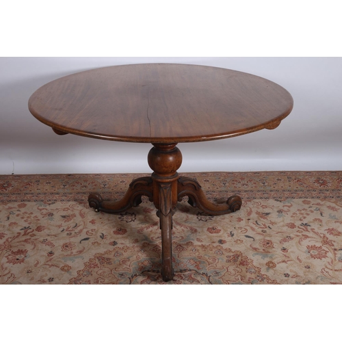 463 - A 19TH CENTURY MAHOGANY POD TABLE the circular moulded top above a baluster column on carved tripod ... 