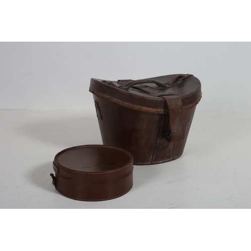 467 - A LEATHER HAT BOX with hinged lid 22cm (h) x 34cm (w) x 35cm (d) containing a leather case monogramm... 