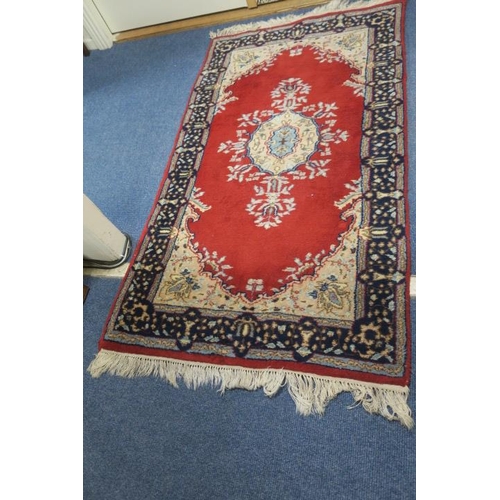 469 - A TABRIZ WOOL RUG the wine ground with central foliate panel within an indigo border 166cm x 86cm