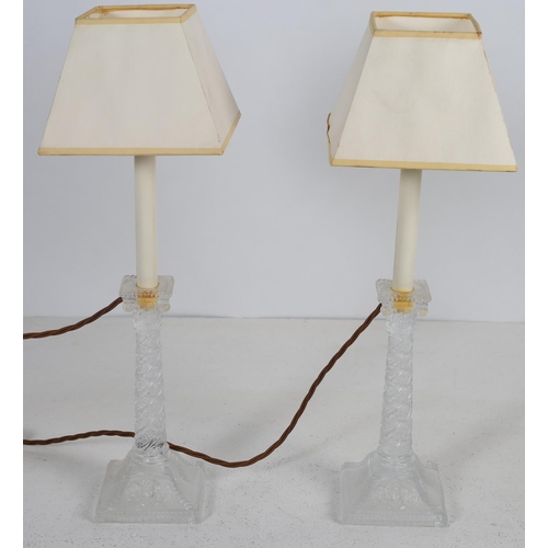 481 - A PAIR OF MOULDED GLASS TABLE LAMPS each with a spiral twist column and scroll capital above a stepp... 