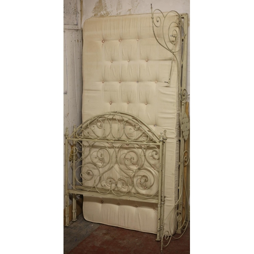 485 - A FRENCH WROUGHT IRON CHILDS BED the rectangular arched headboard with scroll decoration with confor... 