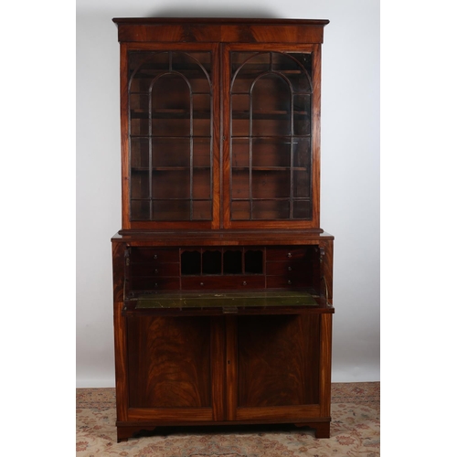 62 - A GEORGIAN MAHOGANY SECRETAIRE LIBRARY BOOKCASE the moulded cornice above a pair of astragal glazed ... 