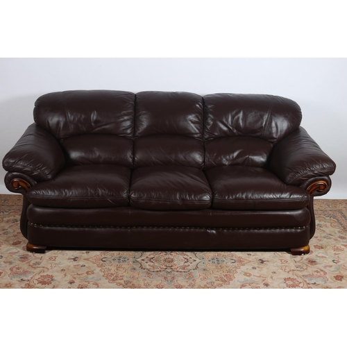 63 - A FAUX LEATHER THREE SEATER SETTEE with scroll over arms on moulded legs  96cm (h) x 220cm (w) x 100... 