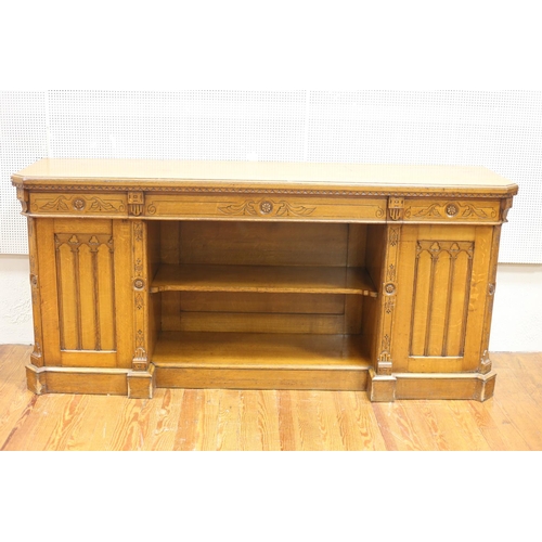 65 - A 19TH CENTURY GOTHIC DESIGN OAK SIDEBOARD of rectangular outline with canted angles and frieze draw... 