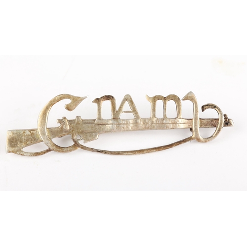 83 - Cumann na mBan, Cork. A white metal Cumann na mBan cap- or lapel-badge, in the form of a Lee Enfield... 