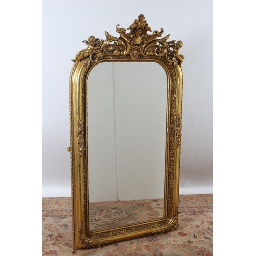 16 - A CONTINENTAL GILT FRAME MIRROR the oval bevelled glass plate within a foliate decorated frame with ... 
