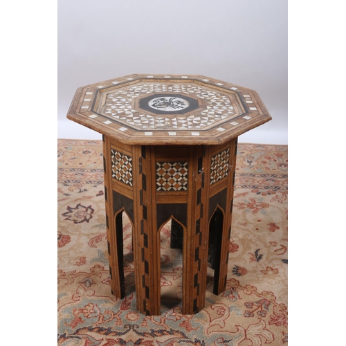 29 - A MOORISH OCCASIONAL TABLE of octagonal outline the shaped dish top with mother of pearl and ebonise... 