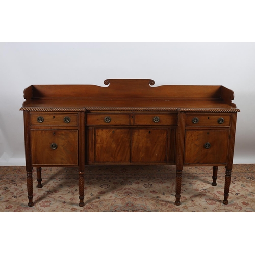3 - A 19TH CENTURY MAHOGANY SIDEBOARD of inverted breakfront outline the shaped top with moulded gallery... 