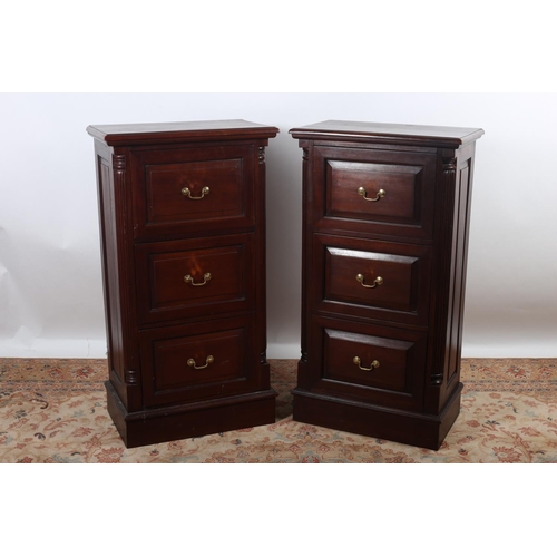 45 - A PAIR OF MAHOGANY THREE DRAWER FILING CABINETS with brass drop handles on platform support 117cm (h... 
