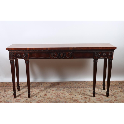 46 - A HEPPLEWHITE DESIGN MAHOGANY SIDE TABLE of rectangular outline the shaped top above a fluted frieze... 