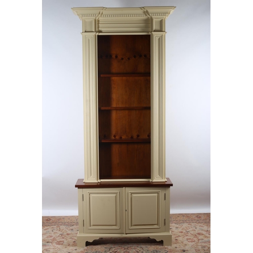 47 - A CHALON PINE AND PAINTED OPEN FRONT BOOKCASE of inverted breakfront outline the dentil moulded corn... 