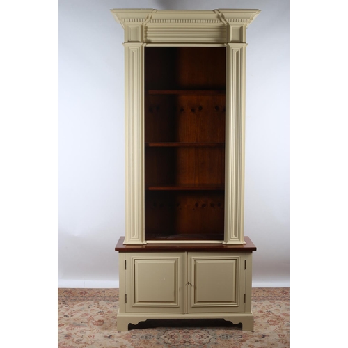 48 - A CHALON PINE AND PAINTED OPEN FRONT BOOKCASE of inverted breakfront outline the dentil moulded corn... 