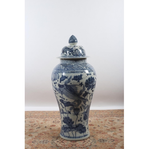 50 - A LARGE ORIENTAL LIDDED GINGER JAR the blue and white ground decorated with stylized flowerheads and... 
