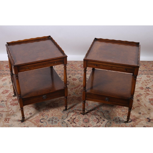 54 - A PAIR OF WALNUT END TABLES each of rectangular outline with moulded gallery above a brush and slide... 