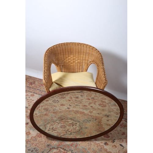 561 - A CANE TUB SHAPED CHAIR together with a vintage mahogany frame mirror of oval outline with bevelled ... 