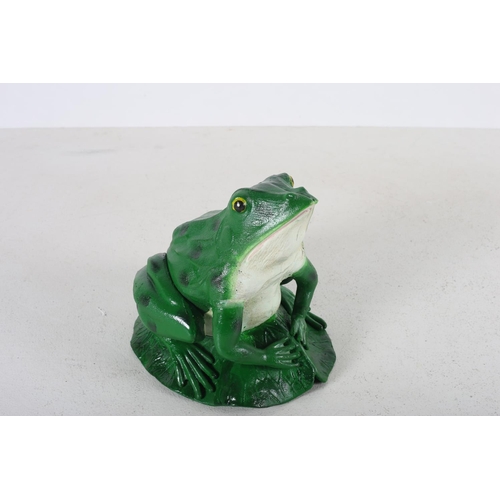 562 - A CAST IRON AND PAINTED FIGURE modelled as a frog shown seated on a lily 24cm (h) x 22cm (w) x 26cm ... 