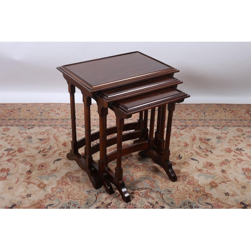 57 - A NEST OF THREE MAHOGANY TABLES each of rectangular outline with dish top raised on dual ring turned... 