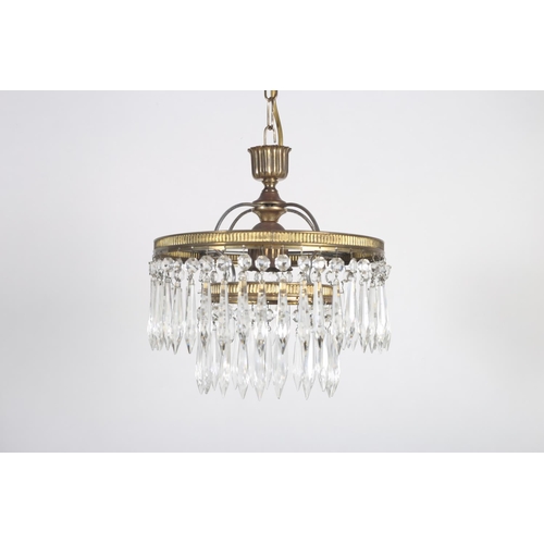 576 - A GILT BRASS AND CUT GLASS TWO TIER CENTRE LIGHT hung with faceted pendants 24cm drop x 25cm (d)