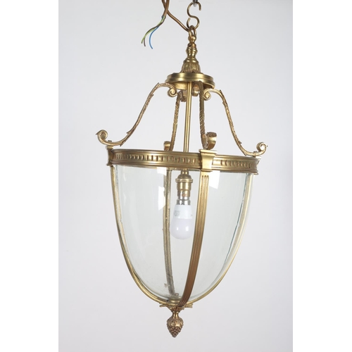 578 - A GILT BRASS AND GLAZED SINGLE LIGHT CENTRE LIGHT of ovoid tapering form with scroll finials 52cm dr... 