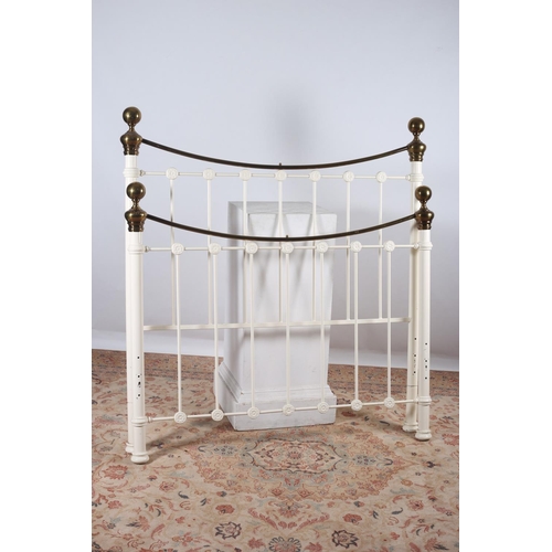 580 - A VICTORIAN DESIGN WHITE PAINTED AND BRASS BED the curved top rail with spherical finials above cyli... 