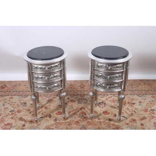 59 - A PAIR OF CONTINENTAL SILVERED AND MARBLE TOP CHESTS each of cylindrical outline surmounted by a vei... 