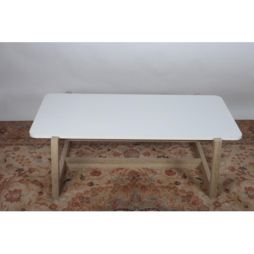 596 - A MODERN WHITE MELAMINE COFFEE TABLE of rectangular form on square moulded supports 42cm (h) x 120cm... 