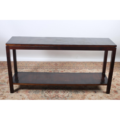 60 - A ROSEWOOD CONSOLE TABLE of rectangular outline the shaped top raised on square moulded legs joined ... 