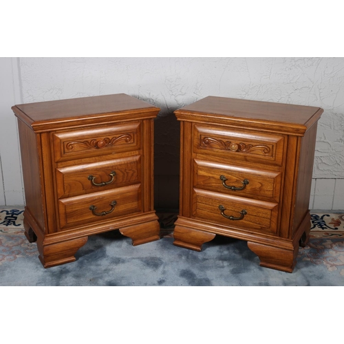 603 - A PAIR OF OAK CHESTS each of rectangular outline the shaped top with three frieze drawers and brass ... 