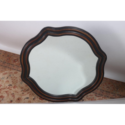 605 - A HARDWOOD FRAME MIRROR the shaped bevelled glass plate within a moulded frame 100 x 96cm