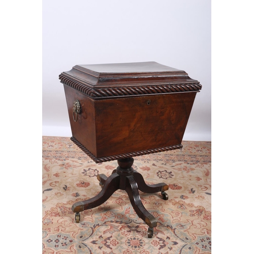 64 - A GEORGIAN MAHOGANY CELLARET of sarcophagus outline the hinged lid with roped decoration raised on b... 