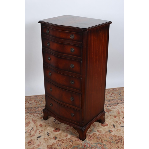 73 - A GEORGIAN DESIGN MAHOGANY TALLBOY of serpentine outline the shaped top above seven long drawers bet... 