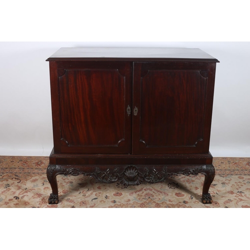 81 - A CHIPPENDALE DESIGN MAHOGANY SIDE CABINET of rectangular outline the shaped top above a pair of pan... 