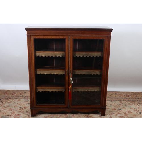 9 - AN EDWARDIAN MAHOGANY AND SATINWOOD INLAID BOOKCASE of rectangular outline the shaped top above a pa... 