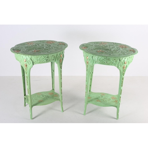 100 - A PAIR OF CAST IRON AND GREEN PAINTED PARCEL GILT TABLES each with an oval shaped top raised on tape... 