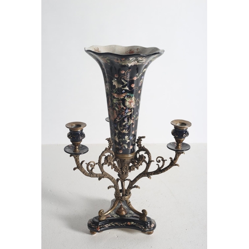 108 - A CONTINENTAL PORCELAIN AND GILT BRASS CANDELABRUM centred by a cornucopia shaped vase above a shape... 