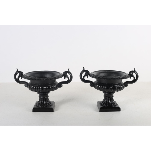 113 - FOUR VICTORIAN DESIGN CAST IRON GARDEN URNS each of semi lobed Campana form with pierced scroll hand... 