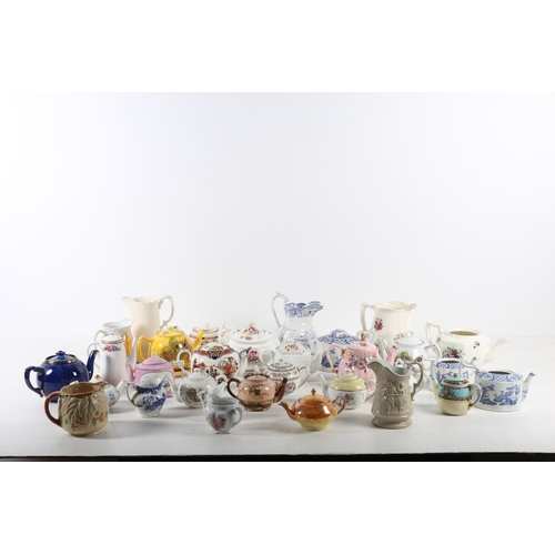 577 - A LARGE COLLECTION OF CHINA to include teapots jugs etc etc on three shelves