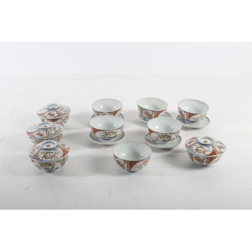 579 - TEN CHINESE FINGER BOWLS ON STANDS the white ground decorated with stylized flowerheads and foliage ... 