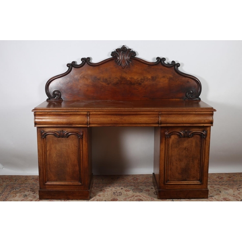 593 - A VICTORIAN MAHOGANY PEDESTAL SIDEBOARD the rectangular top with carved and moulded back with three ... 