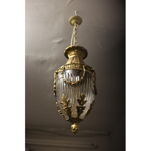 606 - A CONTINENTAL GILT BRASS AND CUT GLASS CENTRE LIGHT of cylindrical tapering form hung with floral fe... 