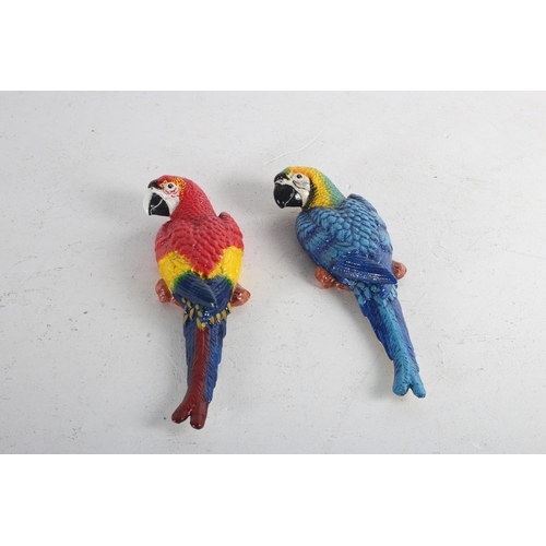 617 - A PAIR OF CAST METAL AND POLYCHROME WALL MOUNTED FIGURES each modelled as a parrot 36cm (h) x 13cm(w... 