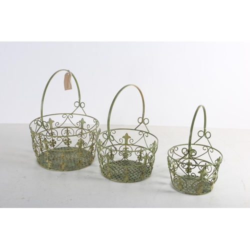 618 - A SET OF THREE WROUGHT IRON GRADUATED BASKETS each with scroll and foliate decoration