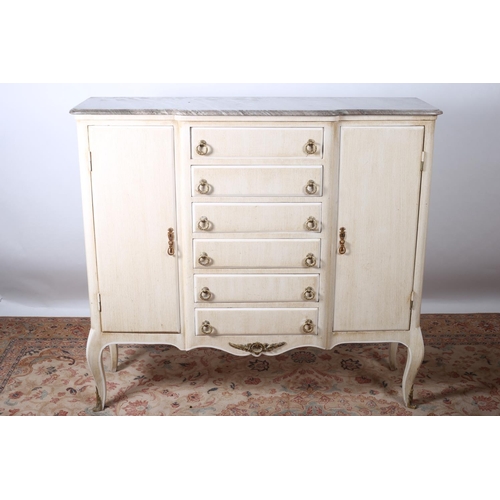 62 - A CONTINENTAL CREAM PAINTED SIDE CABINET of breakfront outline surmounted by a veined marble top and... 