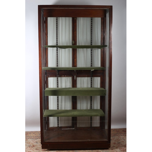 63 - A MAHOGANY AND GLAZED SHOP DISPLAY CABINET of rectangular outline with glazed panels and adjustable ... 